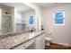 Bright bathroom featuring granite countertops, dual sinks, and modern fixtures at 358 Caffee Dr, Kings Mountain, NC 28086