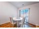 Cozy dining area with modern round table and seating near large window letting in natural light at 358 Caffee Dr, Kings Mountain, NC 28086