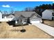 Well-maintained single-story home featuring a two-car garage and landscaping, showcasing a welcoming facade at 358 Caffee Dr, Kings Mountain, NC 28086