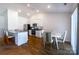 Modern kitchen and dining area featuring stainless steel appliances, white cabinetry, and an eat-in island at 358 Caffee Dr, Kings Mountain, NC 28086