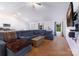 Bright and open living room featuring a large sectional sofa, modern ceiling fan, and seamless flow to the kitchen at 358 Caffee Dr, Kings Mountain, NC 28086