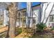 Peaceful backyard view featuring a porch swing, upper balcony, and lush greenery with mature trees at 3615 Maple Glenn Ln, Charlotte, NC 28226