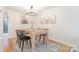 Dining room with hardwood floors, modern light fixture, and view of the kitchen at 3615 Maple Glenn Ln, Charlotte, NC 28226