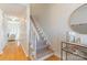 Bright foyer featuring a staircase with carpeted steps and a view into the living room at 3615 Maple Glenn Ln, Charlotte, NC 28226