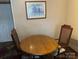 Simple dining area featuring a round wooden table and two upholstered chairs at 410 Yadkin St, Salisbury, NC 28146