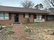 Brick ranch home featuring mature trees and a front door entrance at 410 Yadkin St, Salisbury, NC 28146