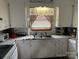 Functional kitchen with white cabinetry, neutral countertops and a bright window at 410 Yadkin St, Salisbury, NC 28146