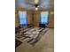 Spacious living room with wood paneled walls, modern rug and ceiling fan at 410 Yadkin St, Salisbury, NC 28146