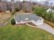 Aerial view of a residential property with a spacious yard, driveway, and surrounding woodland at 4205 Ore Bank Dr, Lincolnton, NC 28092