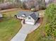 Aerial view of a single-Gathering home with a well-manicured lawn, driveway, and partial wooded surroundings at 4205 Ore Bank Dr, Lincolnton, NC 28092