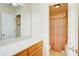 Bright bathroom featuring a vanity with a large mirror and a shower/tub with a patterned curtain at 4205 Ore Bank Dr, Lincolnton, NC 28092