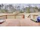 Wooden deck with railing overlooking a large backyard with mature trees and a shed at 4205 Ore Bank Dr, Lincolnton, NC 28092