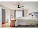 A cozy main bedroom with hardwood floors, ceiling fan, and upholstered seating at 4205 Ore Bank Dr, Lincolnton, NC 28092