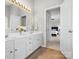 Bright bathroom with double sink vanity, modern lighting, and view to main bedroom at 421 Silver Cypress Ln, Fort Mill, SC 29708