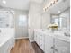 Bright bathroom featuring a double sink vanity, bathtub, and glass-enclosed shower at 421 Silver Cypress Ln, Fort Mill, SC 29708