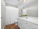 Bright bathroom featuring a vanity, toilet, shower and a towel rack at 421 Silver Cypress Ln, Fort Mill, SC 29708