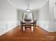 Traditional dining room with hardwood floors, wainscoting, and a window at 421 Silver Cypress Ln, Fort Mill, SC 29708