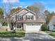 Attractive two-story home features a two-car garage, basketball hoop, and beautifully landscaped front yard at 421 Silver Cypress Ln, Fort Mill, SC 29708