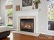 Close up of cozy fireplace with white mantle and marble hearth at 421 Silver Cypress Ln, Fort Mill, SC 29708