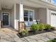 Inviting front porch with comfortable seating, decorative columns, and a well-kept garden at 421 Silver Cypress Ln, Fort Mill, SC 29708