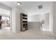 Bright hallway with a bookcase and an open doorway leading to another room at 421 Silver Cypress Ln, Fort Mill, SC 29708