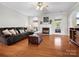 Spacious living room with hardwood floors, a fireplace, and comfortable seating at 421 Silver Cypress Ln, Fort Mill, SC 29708