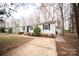 Charming single-story home with a well-kept lawn, black shutters, and a concrete driveway at 4910 Lailwood Cir, Charlotte, NC 28227