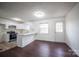 Open-concept kitchen with white cabinets, modern appliances, and a breakfast bar seamlessly connects to dining at 4910 Lailwood Cir, Charlotte, NC 28227