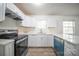 Bright kitchen features white cabinets, modern countertops, and stainless steel appliances for a clean, updated look at 4910 Lailwood Cir, Charlotte, NC 28227