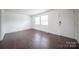 Bright living room featuring hardwood floors, large windows, and a welcoming front door at 4910 Lailwood Cir, Charlotte, NC 28227