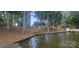A waterfront property with a tree-filled backyard sloping gently to a lake at 604 Fairway Shores Rd, Mount Gilead, NC 27306