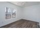 A bright bedroom featuring hardwood floors, a ceiling fan, and a large window with natural light at 604 Fairway Shores Rd, Mount Gilead, NC 27306