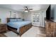 This bedroom features a ceiling fan, a window with natural light, and hardwood floors at 604 Fairway Shores Rd, Mount Gilead, NC 27306