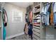 Walk-in closet with custom shelving and ample storage space for clothes and accessories at 604 Fairway Shores Rd, Mount Gilead, NC 27306