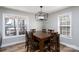 Dining area with a modern light fixture and views of the outdoors through large windows at 604 Fairway Shores Rd, Mount Gilead, NC 27306