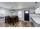 Inviting dining area features a modern chandelier, a large table, and stylish decor for cozy meals at 604 Fairway Shores Rd, Mount Gilead, NC 27306