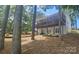 Two story house with a covered porch, gray siding, and a tiered landscaped yard at 604 Fairway Shores Rd, Mount Gilead, NC 27306