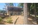 Two story home with a black porch, gray siding, and mature trees surrounding the property at 604 Fairway Shores Rd, Mount Gilead, NC 27306