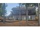 Two story home with a covered porch and black trim, as well as mature landscaping at 604 Fairway Shores Rd, Mount Gilead, NC 27306