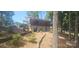 Gray home with black trim and mature trees surrounding it at 604 Fairway Shores Rd, Mount Gilead, NC 27306
