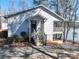 Inviting home exterior featuring a cozy front porch and lake views at 604 Fairway Shores Rd, Mount Gilead, NC 27306