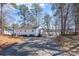 Charming home with a long driveway is nestled among trees, offering both privacy and scenic views at 604 Fairway Shores Rd, Mount Gilead, NC 27306