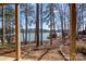 Scenic lake view from the house, framed by trees and landscaping at 604 Fairway Shores Rd, Mount Gilead, NC 27306