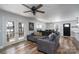 Open-concept living room with stylish ceiling fan, wood floors and doors leading to back deck at 604 Fairway Shores Rd, Mount Gilead, NC 27306