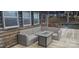 Outdoor wicker furniture set with a metal-trimmed table sitting on a wood deck by the water at 604 Fairway Shores Rd, Mount Gilead, NC 27306