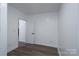 A simple room with hardwood floors features a door to another room and white trim at 604 Fairway Shores Rd, Mount Gilead, NC 27306