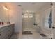 Modern bathroom featuring a glass-enclosed shower, sleek gray cabinets, and white marble countertops at 615 R L Stowe Rd, Belmont, NC 28012