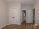 Bedroom with wood-look floors, closet and bathroom doors, and white trim at 615 R L Stowe Rd, Belmont, NC 28012