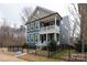 Charming two-story home with a covered porch and black aluminum fencing at 615 R L Stowe Rd, Belmont, NC 28012