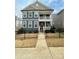 Charming two-story home with a welcoming front porch and black metal fence at 615 R L Stowe Rd, Belmont, NC 28012